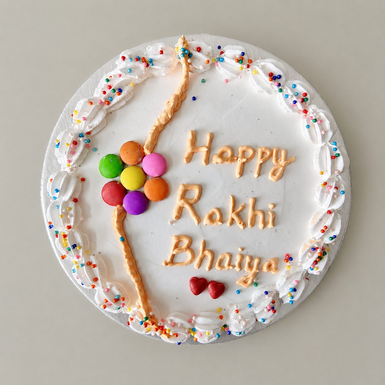 Happy Rakhi Bhaiya Cake with Rakhi design, colourful sprinkles, candy decoration, and festive cream border for Raksha Bandhan celebration