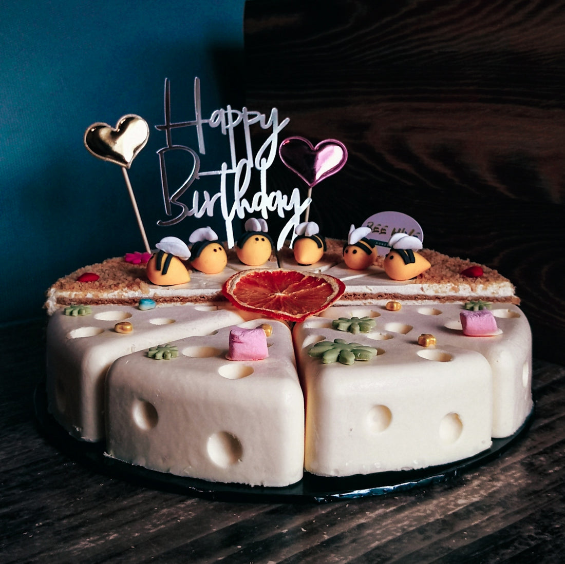 a birthday cake with candles and decorations on a table
