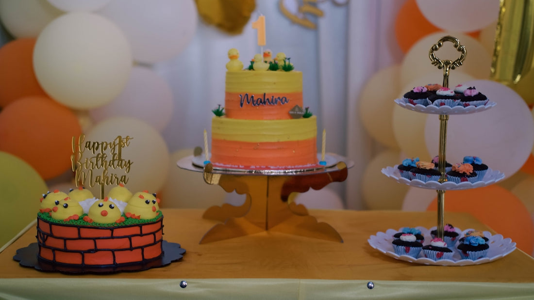 a table with a cake and cupcakes on it