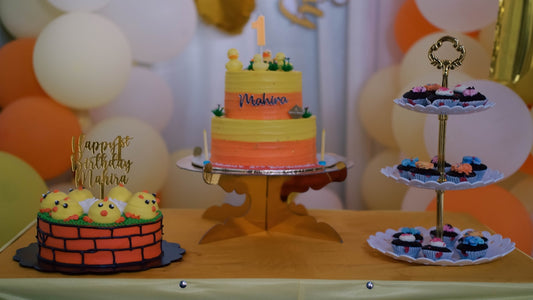 a table with a cake and cupcakes on it