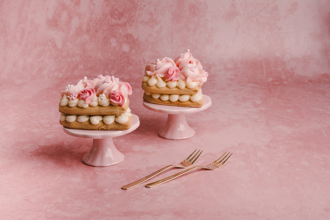 two cakes sitting on top of a white cake stand