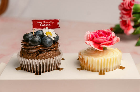 a couple of cupcakes sitting on top of a white plate