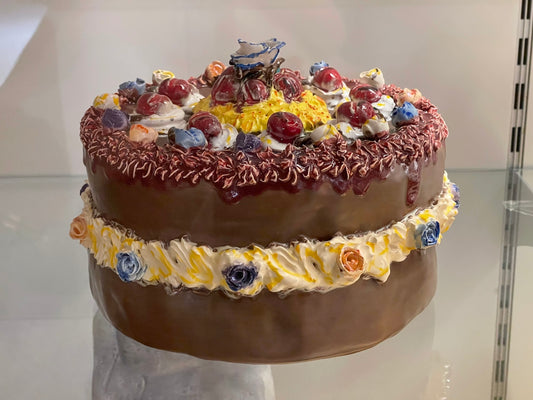 A chocolate cake sitting on top of a glass table